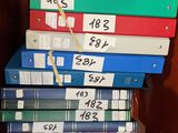 books stacked on top of each other on a shelf in a book case