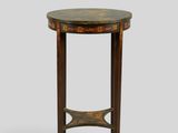 une table ronde avec un plateau en marbre et des pieds en bois