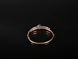 a gold ring on a black surface