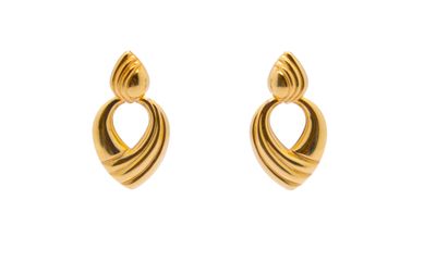 the gold earrings are shaped like a heart