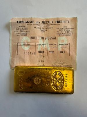 a gold bar sitting on top of a piece of paper