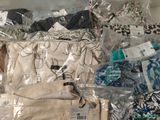 a lot of clothes that are in bags on the floor