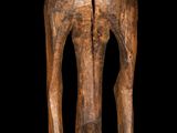 an image of a wooden sculpture of a woman with a bird on her head