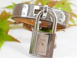 a silver watch with a padlock attached to it
