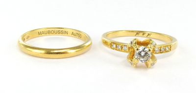 pair of yellow gold wedding rings with a diamond center stone