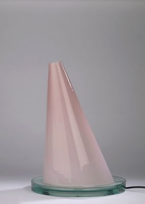 a pink cone shaped object on a glass plate