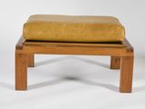 a wooden bench with a yellow cushion on it