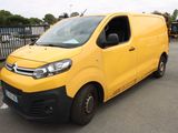 a yellow van that is parked in a parking lot