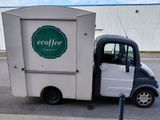 a small truck that is parked on the side of the road
