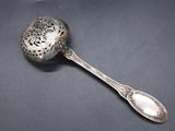 an antique silver spoon with a flower design on the handle