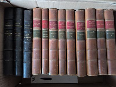 de nombreux livres anciens dans une boîte posée sur une table