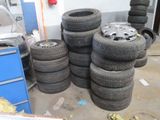 a lot of tires stacked on top of each other in a garage