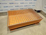 a close up of a metal grate on top of a wooden pallet