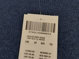 the label on the back of a blue sweater is attached to a hanger