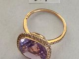 an amethorate and diamond ring on display at a jewelry store