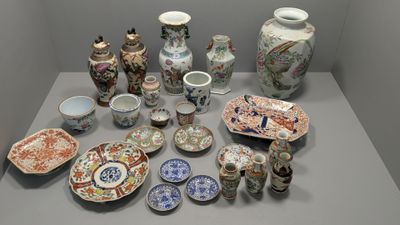 many different types of vases and plates on the table