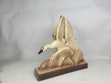a statue of a bird that is flying in the air