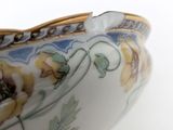 a close up of a bowl with flowers on it