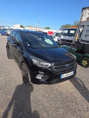 the black ford kuga is parked in the parking lot