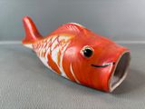 a small red fish that is sitting on a table