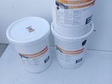 three buckets of paint sitting next to each other on the floor