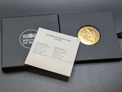 a close up of a gold coin in a black box