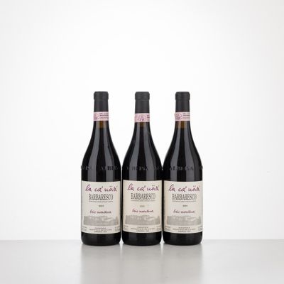three bottles of wine sitting on top of a table next to each other
