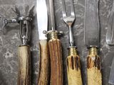 many different types of knives and knives laid out on a table
