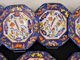 six blue and orange plates with floral designs on them on a table