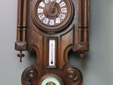 a wooden clock hanging on the wall in a room