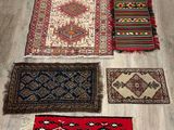 several rugs and rugs laid out on a wooden floor