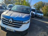 a blue and white van parked in a parking lot