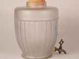 a glass jar with a cork top and a faucet on the side