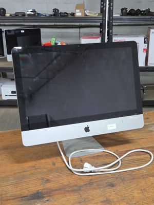 a computer monitor sitting on top of a wooden desk