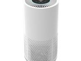 a white air purifier sitting on top of a white table