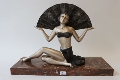 a statue of a woman with a fan on a marble base