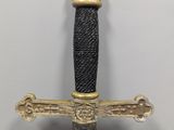 a gold and black sword with a crown on top of it