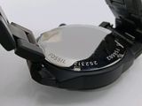 a close up of a watch on a white surface