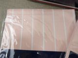 a pink and white striped shirt on a table