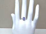 a hand with a ring that has a tan sapphire on it
