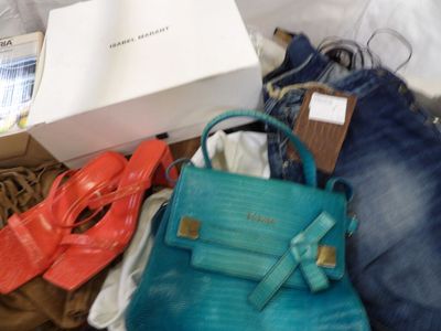 a blue purse and a pair of red shoes next to a box