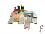 a pile of old books sitting on a white surface
