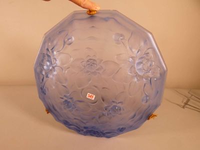 a hand that is holding a blue vase on a table