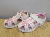 pink and white sandals with flowers on them sitting on a wooden table