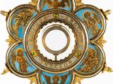 a gold and blue cross with angels on it
