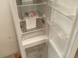 a white refrigerator with its door open on a pallet