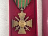 two medals are in a red box with a ribbon around them