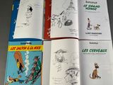 several children ' s books are lined up on a table