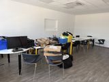 a room with a lot of desks and chairs in it