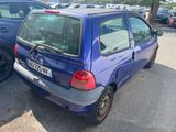 a small blue car that is parked in a parking lot